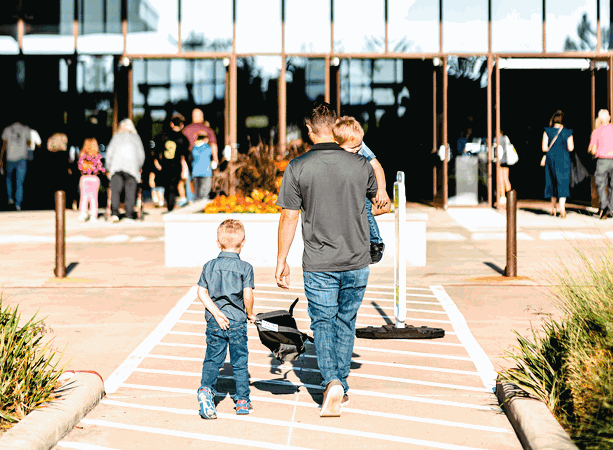 Man walking his kids into church